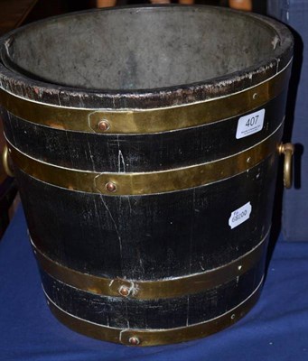 Lot 407 - Staved oak bucket with brass mounts and liner