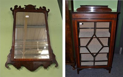 Lot 564 - An Edwardian mahogany inlaid glazed cabinet and a mahogany framed fret carved wall mirror