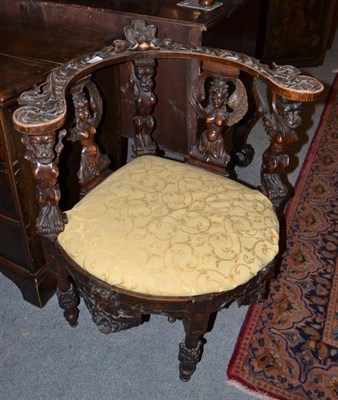 Lot 574 - A 19th century carved walnut corner chair