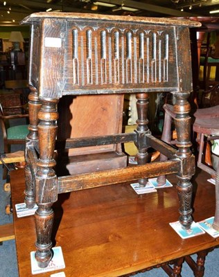 Lot 580 - A 19th century carved oak stool with hinged compartment