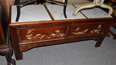 Lot 585 - Oriental hardwood low table with marble top and sliding doors, gilt and applied decoration