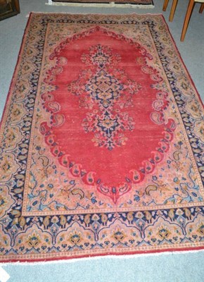 Lot 589 - Kirman rug, South East Persia, the plain blood red field with central medallion framed by...