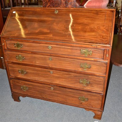 Lot 606 - A George III mahogany bureau, the interior fitted with an arrangement of boxwood strung drawers