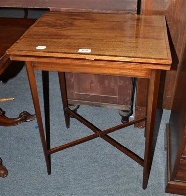 Lot 615 - An Edwardian mahogany inlaid fold-over games table