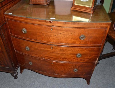 Lot 620 - An early 19th century mahogany bow fronted three height chest of drawers with glass top