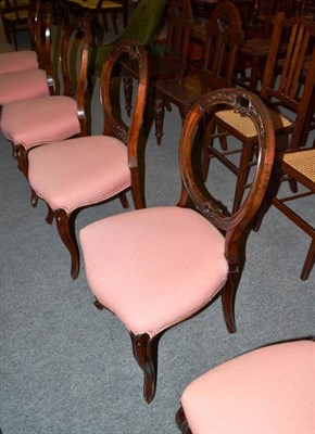 Lot 632 - A set of six Victorian walnut balloon back chairs with pink seats