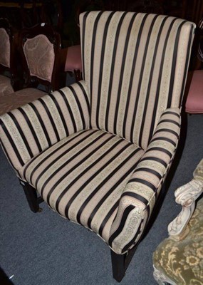 Lot 634 - A mahogany framed armchair with black and floral striped upholstery