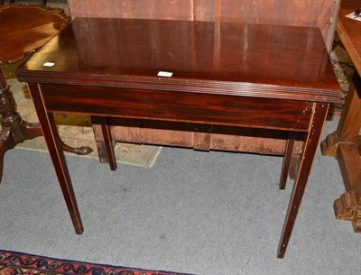 Lot 670 - A dark mahogany inlaid fold-over tea table