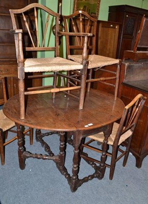 Lot 686 - Oak gateleg dining table and six rush seated chairs