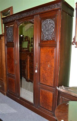 Lot 695 - A late Victorian carved walnut triple wardrobe