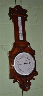 Lot 709 - Carved oak wheel barometer