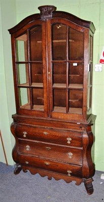 Lot 722 - A 18th century style Continental oak cabinet on bombe base, 101cm wide