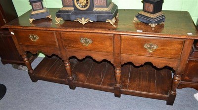 Lot 726 - An 18th century oak dresser base with three drawers