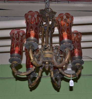 Lot 742 - A 19th century bronze chandelier with putti and six cranberry glass shades, 67cm drop