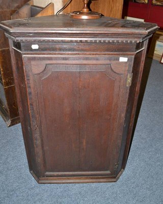 Lot 765 - A Georgian oak hanging corner cabinet