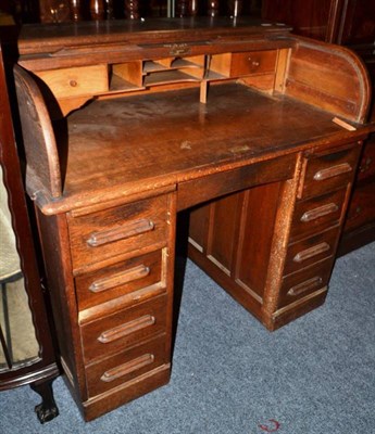 Lot 780 - An oak roll top desk