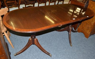 Lot 795 - A mahogany reproduction twin pedestal dining table with one leaf