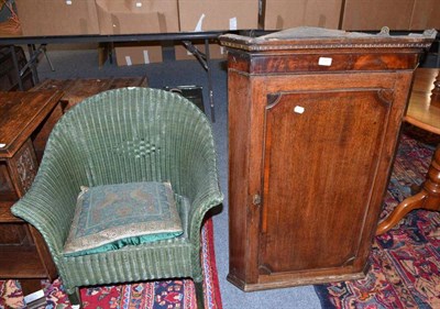 Lot 808 - Oak corner cupboard and a Lloyd Loom style chair