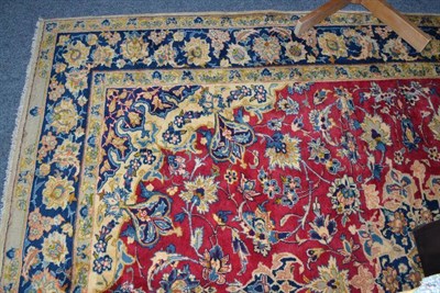 Lot 823 - A West Persian carpet, probably Sarukh, the raspberry field of floral vines centred by a...