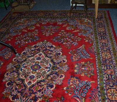 Lot 843 - A Tabriz carpet, the blood red field with floral sprays around a medallion framed by floral...