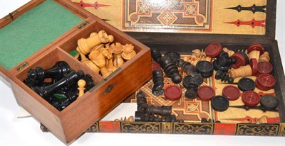 Lot 9 - A boxwood and ebony Staunton chess set, and a book form backgammon and games board containing small