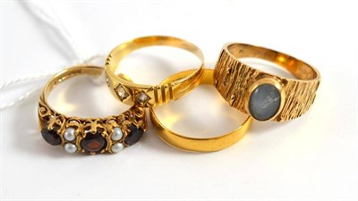 Lot 65 - A 22ct gold ring, two yellow metal rings and a garnet and pearl-set ring
