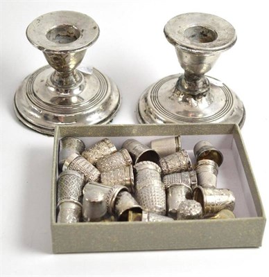 Lot 97 - Collection of silver and other thimbles and a pair of dwarf candlesticks