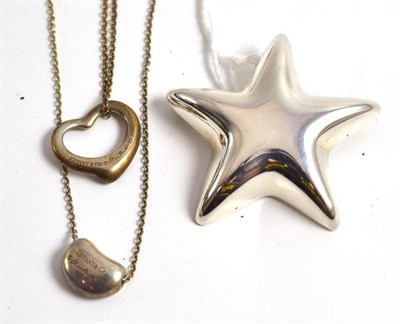 Lot 109 - Two Tiffany & Co pendants and a star brooch