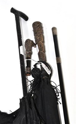 Lot 131 - Indian silver mounted umbrella, an ebony handled parasol, silver banded cane and silver camel...