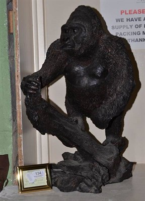 Lot 134 - A Bowbrook limited edition gorilla figure on a rocky base with three gorilla prints