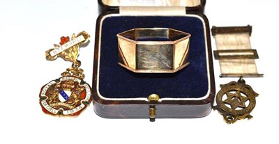 Lot 217 - A 9ct gold napkin ring and three silver and enamel Masonic jewels