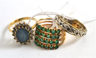 Lot 232 - An emerald stacking ring, an opal triplet ring and an eternity ring