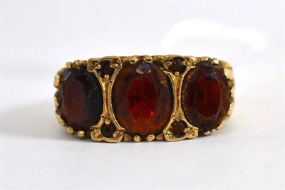 Lot 259 - A 9ct ring set with garnets (worn)