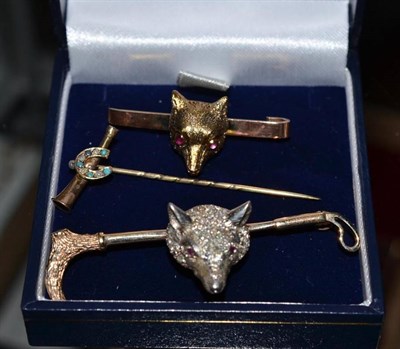 Lot 262 - A diamond set fox mask brooch, another fox mask brooch and a horseshoe and horn brooch set with...