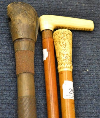 Lot 291 - An Edwardian malacca walking cane with 18th century Indian ivory pommel carved with figures; an...