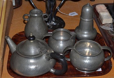 Lot 295 - A Liberty & Co Tudric three piece pewter tea service 01075, a caster 01389 and a vase 01219 (5)