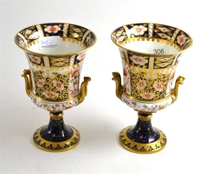 Lot 306 - Pair of Royal Crown Derby pedestal urn vases, painted and gilt in the Old Imari palette,...