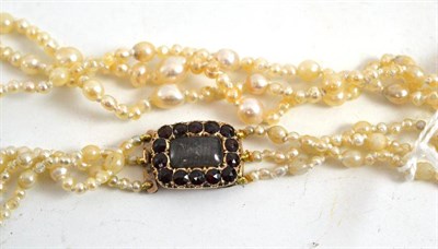 Lot 382 - A pearl necklace with garnet clasp