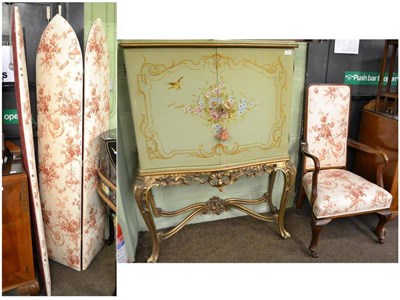 Lot 536 - A green floral painted cocktail cabinet in the Louis XV style, a three leaf screen and a...