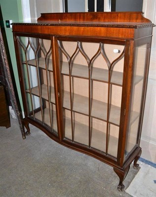 Lot 546 - A 1930's mahogany serpentine-front display cabinet