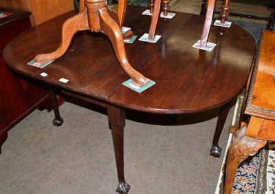 Lot 568 - A mahogany gateleg dining table with ball and claw feet