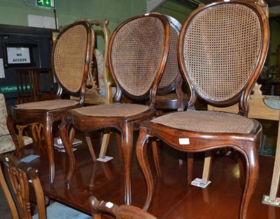 Lot 571 - A set of four 19th century bergere salon chairs with cabriole front legs and balloon backs (4)