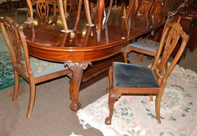 Lot 572 - A Chippendale style mahogany dining suite on foliate carved cabriole legs, comprising a dining...