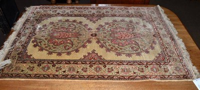 Lot 584 - A Hereke silk rug, the cream field with two roundel medallions framed by pale mint borders, 109...