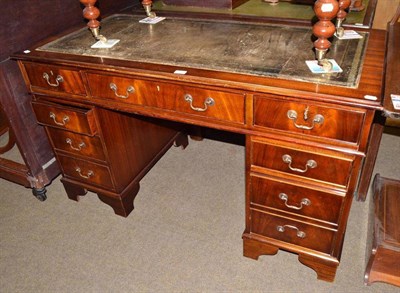 Lot 634 - A reproduction mahogany pedestal desk