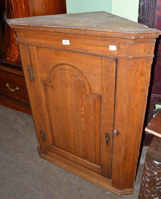 Lot 650 - A Georgian oak straight front hanging corner cupboard