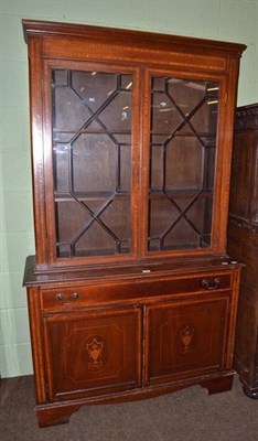 Lot 653 - An Edwardian inlaid mahogany bookcase with cupboard base