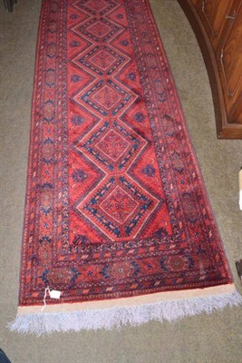 Lot 667 - A narrow Afghan runner, Afghan Turkestan, the tomato field with a column of linked diamond...