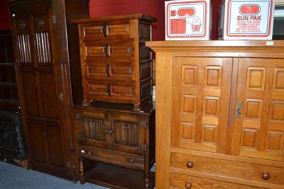 Lot 690 - An oak linen fold-carved hall robe, a similar cupboard and an oak cupboard and chest of drawers...