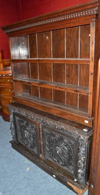 Lot 691 - Late Victorian carved oak cupboard, an oak dwarf bookcase, a carved oak two tier trolley and a...